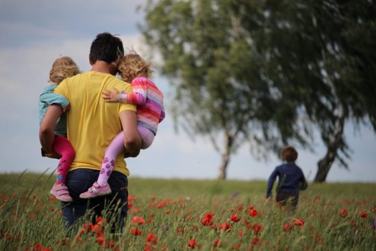 Family in field thinking of future