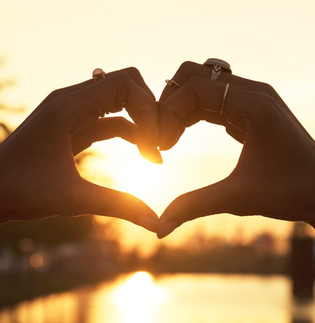 Woman making heart shape with hand
